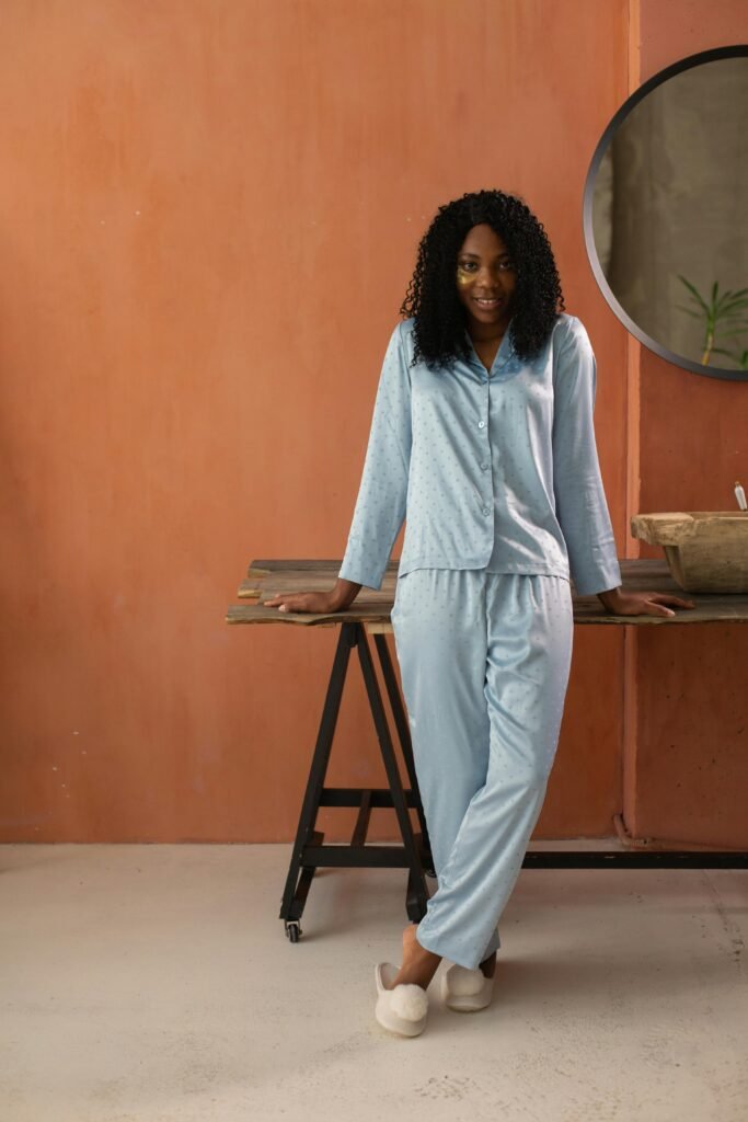 Woman in light - blue dotted pajamas by table
